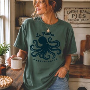 Woman wearing blue spruce monochromatic Comfort Colors octopus graphic tee.