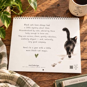 Back cover of illustrated black cat calendar with watercolor walking cat, paw prints and poetic black cat message