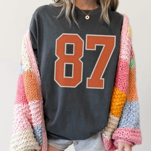 Pepper grey Comfort Colors shirt with varsity Kelce’s football number “87”