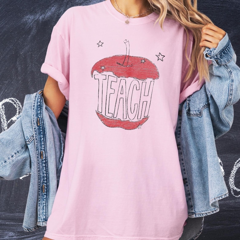 Soft pink teacher t shirt with hand sketched apple core and TEACH text, artsy minimalist teacher shirt with child drawn vintage look