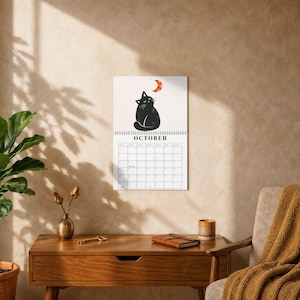 October black cat calendar page with watercolor black cat looking at orange crescent moon, cozy seasonal cat artwork