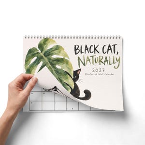 2027 black cat wall calendar with watercolor cat and green monstera leaf cover, illustrated calendar gift for cat lover