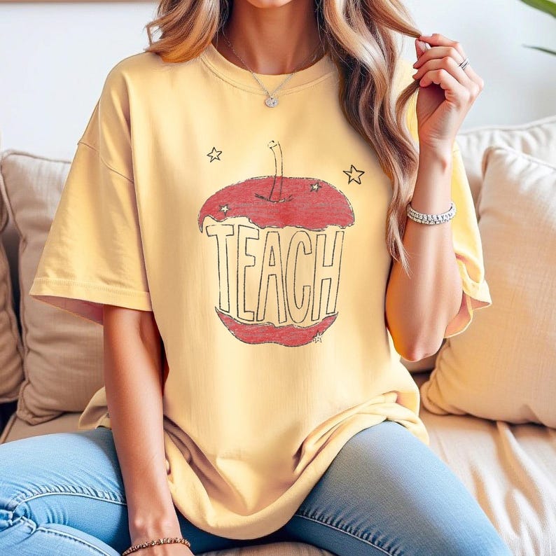 Aesthetic teacher shirt in butter yellow featuring hand drawn apple with TEACH lettering, vintage sketch style teacher tee inspired by Anthropologie