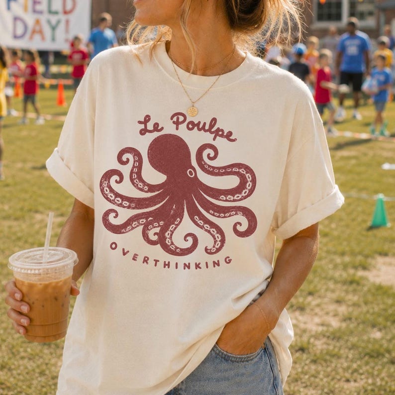 Woman wearing ivory Comfort Colors octopus graphic tee outdoors.