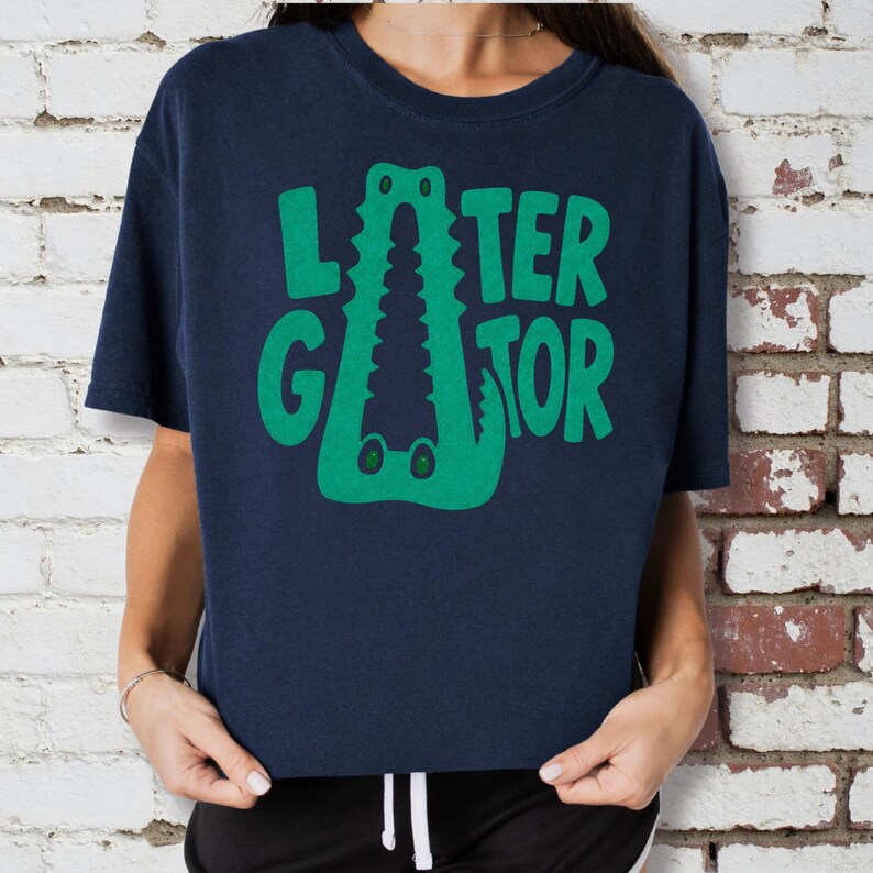 NAVY Comfort Colors close up graphic tee featuring a playful Later Gator alligator illustration forming the letter A in chunky retro green typography.