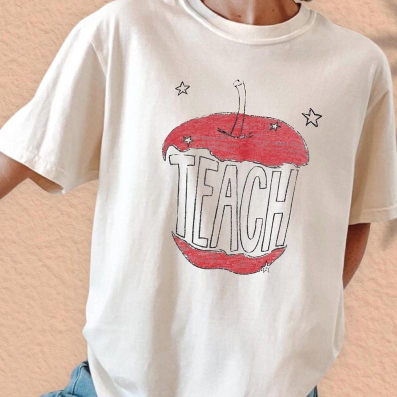 Hand drawn TEACH apple shirt for teachers on ivory tee, vintage childlike apple sketch with imperfect pencil lines and red crayon texture, Free People inspired teacher style