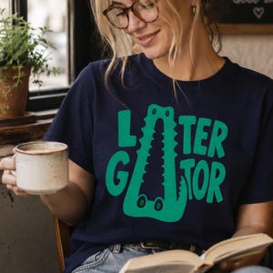 TRUE NAVY Comfort Colors graphic tee featuring a playful Later Gator alligator illustration forming the letter A in chunky retro green typography.