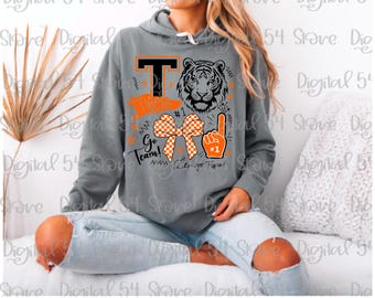 May include: Gray hooded sweatshirt with a tiger graphic and the word "Tigers". The design includes a bow, a foam finger, and the phrases "Go Team!" and "Let's go Tigers!" in orange and black.