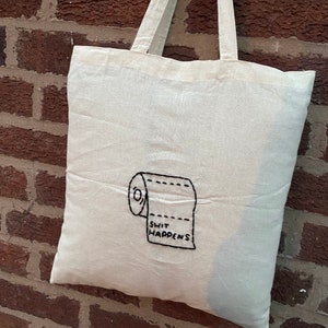 手刺繍の「Shit happens」トートバッグ