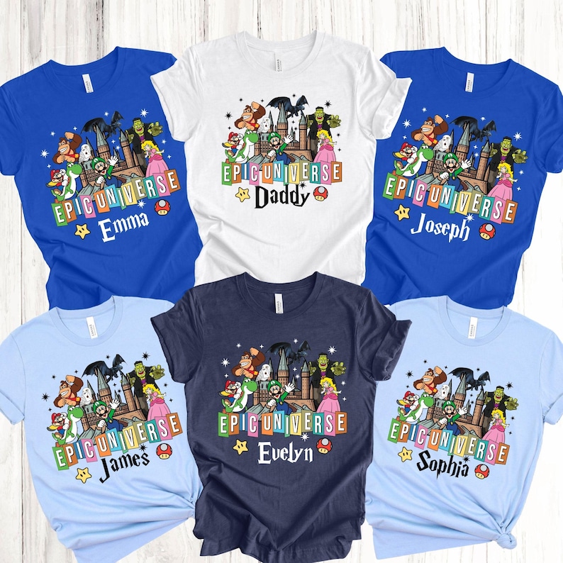 May include: A collection of colorful t-shirts featuring a cartoon graphic with the text "EPIC UNIVERSE" and names like "Emma", "Daddy", "Joseph", "James", "Evelyn", and "Sophia". The shirts are in various colors, including blue, white, and navy.