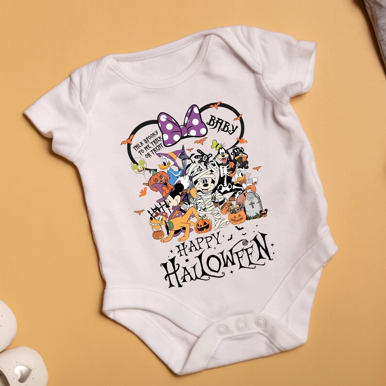 May include: White baby onesie with a Halloween-themed graphic. The design features Mickey Mouse, Minnie Mouse, Donald Duck, and other Disney characters in Halloween costumes. The text reads "Talk Spooky to Me Trick or Treat" and "Happy Halloween".