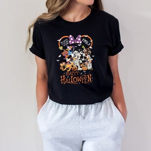May include: Black t-shirt featuring a Halloween design with Disney characters. The design includes a purple bow, the name "Emily", and the words "Happy Halloween". Various cartoon characters are dressed in Halloween costumes.