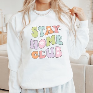 Stay Home Club sweatshirt for cozy lounging Elevate your stay at home experience with this comfy pullover the perfect homebody gift designed for stylish relaxation and comfort.