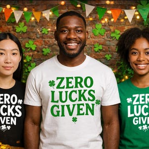 May include: Three people wearing t-shirts with the text "ZERO LUCKS GIVEN" and shamrock graphics. The shirts are black, white, and green. The background includes shamrock decorations and a green top hat.