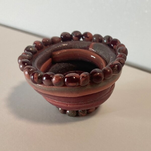 Small clay bowl pink red bronze