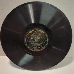 May include: A vintage black vinyl record with a gold and black label. The label reads "Victor" and features the title "Whispering Hope" by Olive Kline and Elsie Baker. The record is a classic music collectible.