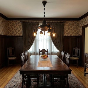 May include: A formal dining room featuring a large, dark wood dining table with seating for eight. The room has ornate wooden paneling, floral wallpaper, and heavy brown curtains. A chandelier hangs above the table, and a rug covers the floor.