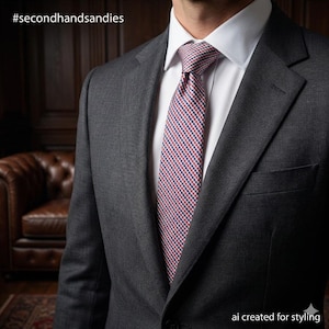 May include: A charcoal gray suit with a white dress shirt and a patterned tie. The tie features a red, white, and blue checkered design. The image includes the text "#secondhandsandies" and "ai created for styling".