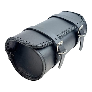 May include: Black leather motorcycle saddlebag with a braided trim and two buckles.