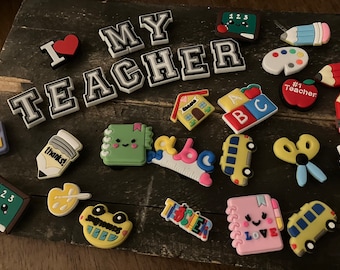 Teacher croc charms pick 5. Message me with the 5 you choose.