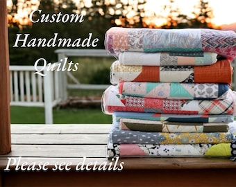 May include: A stack of custom handmade quilts in various colors and patterns. The quilts are folded neatly, showcasing a variety of fabrics and designs. Text on the image reads "Custom Handmade Quilts. Please see details."