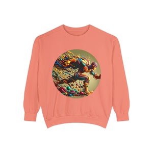 May include: Coral-colored sweatshirt featuring a vibrant, abstract design of a running figure within a circular frame. The artwork showcases a dynamic blend of colors, including blue, orange, yellow, and green, creating a sense of movement and energy. The sweatshirt has long sleeves.