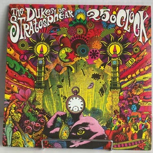 May include: A psychedelic album cover featuring a clock face with a large eye and a muscular arm holding a pocket watch. The background is a vibrant mix of colors and patterns, including a peace sign, a red star, and two towers.