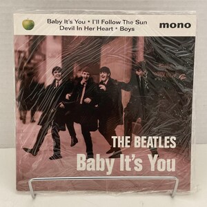 May include: A vintage vinyl record album by The Beatles, titled "Baby It's You." The album cover features a pink background with a photo of the band members. The text "Baby It's You" is prominently displayed.
