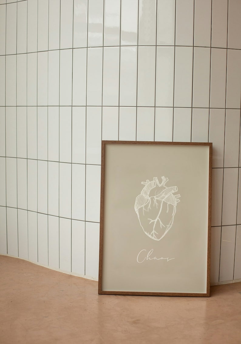Illustration sketch of a human heart in white pencil. Written underneath says Chaos.