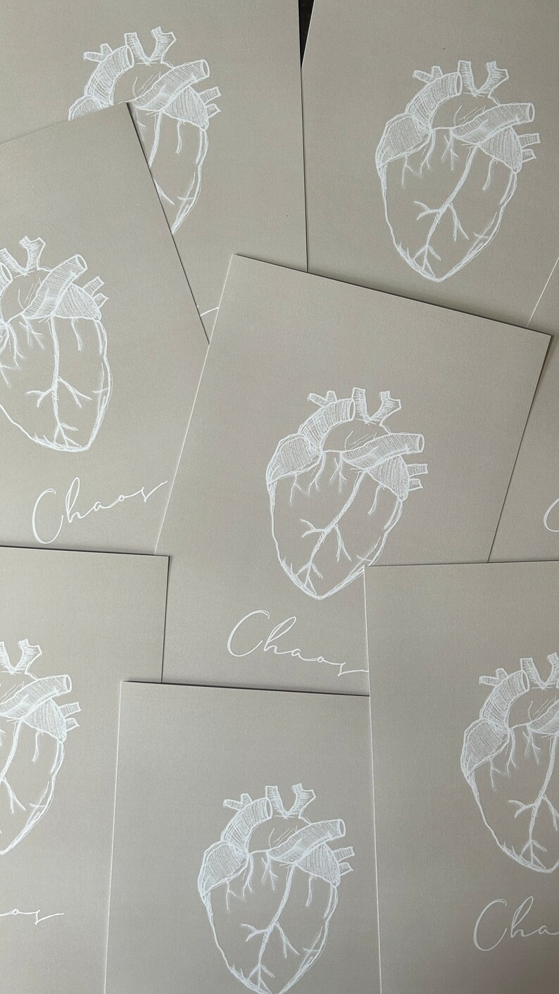 May include: A set of six beige cards with a white anatomical heart illustration and the word "Chaos" written in cursive on each card.