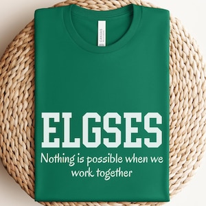 May include: Green t-shirt with white text that reads "ELGSES Nothing is possible when we work together".