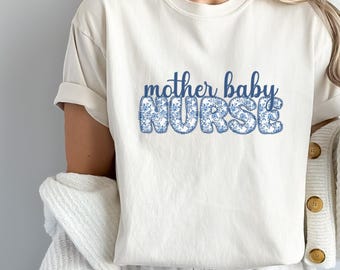 May include: White t-shirt with the text "mother baby NURSE" in blue with a floral pattern.