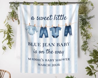 May include: A baby shower banner with a blue and white striped background. The banner features the text "a sweet little" above illustrations of baby clothes. Below, it reads "BLUE JEAN BABY is on the way" and "MADDIE'S BABY SHOWER MARCH 2026".