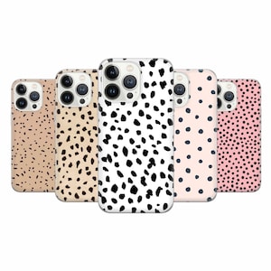 May include: Five different iPhone cases with various animal print designs. The cases feature a black and white dalmatian print, a black and white polka dot print, a pink and black polka dot print, a brown and black dalmatian print, and a beige and black dalmatian print.