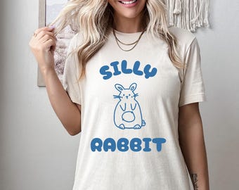 May include: A white t-shirt with a blue graphic of a cartoon rabbit and the text "Silly Rabbit".