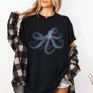 May include: A black t-shirt with a graphic of a blue and white octopus. The octopus is in a x-ray style design.