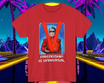 May include: Red t-shirt with a graphic of a man in a red suit with a V on his chest. The text "Friendship is Universal" is printed below the graphic.