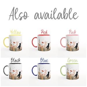 May include: Six white ceramic mugs with a floral and black cat illustration. The text "Also available" appears at the top. Each mug features a different colored handle and rim: yellow, red, pink, black, blue, and green, labeled accordingly.