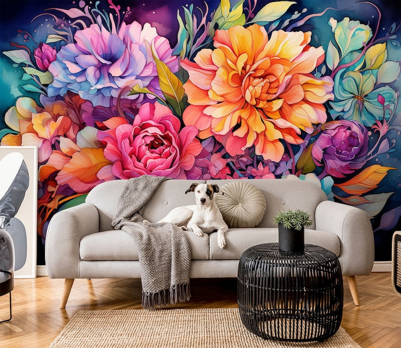 May include: A vibrant floral mural featuring large, colorful blooms in shades of pink, orange, purple, and blue. A light gray sofa with a dog and a throw blanket sits in front of the mural. A black wicker side table and a small potted plant complete the scene.
