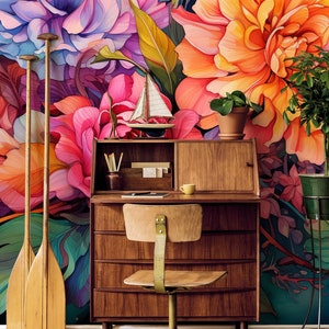 May include: A mid-century modern desk and chair set against a vibrant floral mural. The desk is made of wood and has drawers and a small hutch. Decorative oars lean against the wall. A small sailboat and potted plant add to the decor.