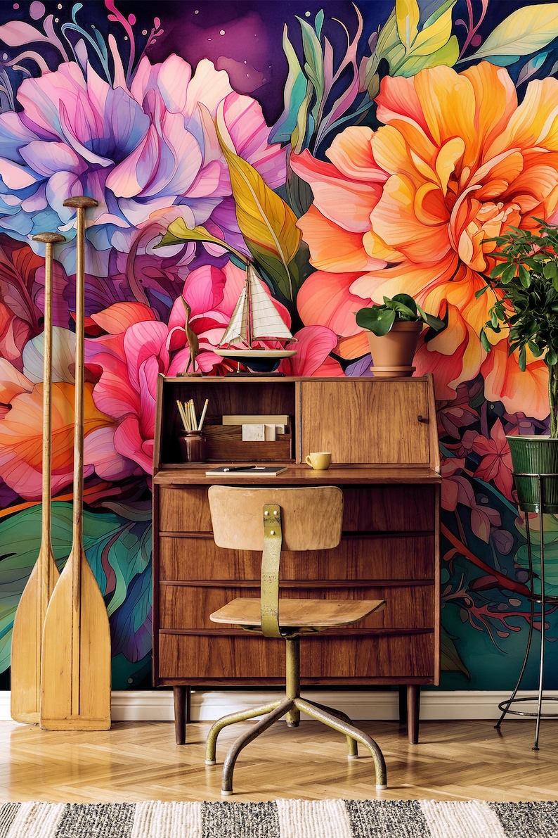 May include: A mid-century modern desk and chair set against a vibrant floral mural. The desk is made of wood and has drawers and a small hutch. Decorative oars lean against the wall. A small sailboat and potted plant add to the decor.