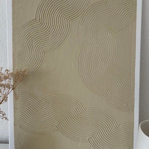 May include: A beige canvas painting with a textured, abstract design of overlapping curved lines.