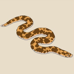 May include: Cross-stitch pattern for a Kenyan Sand Boa, a snake with brown and orange markings on an ivory background. The pattern is 130 stitches wide by 90 stitches high, and requires 7 skeins of ivory thread.