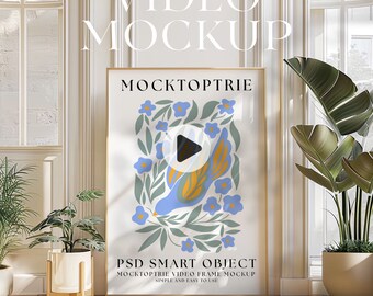 May include: A framed video mockup with a gold frame and a white background. The image inside the frame features a blue bird with yellow accents, surrounded by green leaves and blue flowers. The text "MOCKTOPTRIE" is at the top of the frame, and the text "PSD SMART OBJECT" is at the bottom of the frame. The text "MOCKTOPTRIE VIDEO FRAME MOCKUP" is below the "PSD SMART OBJECT" text. The text "SIMPLE AND EASY TO USE" is below the "MOCKTOPTRIE VIDEO FRAME MOCKUP" text.