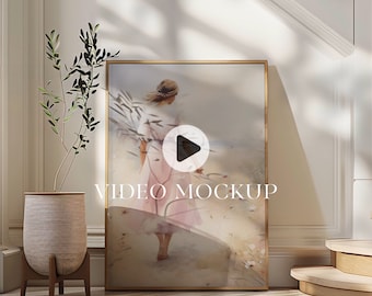 May include: A framed painting of a woman walking on a beach with a play button overlayed on the image. The text "VIDEO MOCKUP" is below the play button.