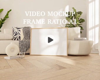May include: A white couch with a black and white patterned throw blanket and a white vase with a round design. A framed video mockup with the text "VIDEO MOCKUP FRAME RATIO A1" is on the wall behind the couch.