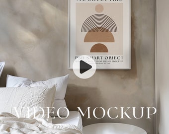 May include: A white bed with a white comforter and two white pillows. A framed print with a geometric design in brown and black hangs on the wall above the bed. The print has the text "MOCKTOPTRE" and "PSD SMART OBJECT" on it. A white side table is next to the bed.