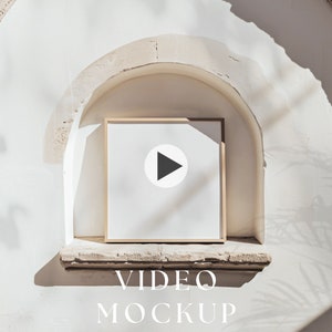 May include: A white video mockup in a light wood frame with a play button icon, set against a white wall with a stone archway.