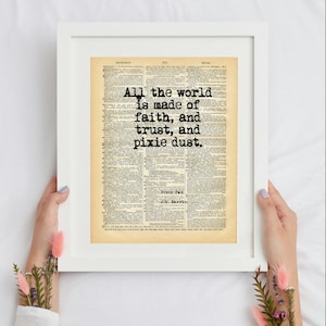 May include: A framed print featuring a vintage dictionary page with the black text All the world is made of faith, and trust, and pixie dust. The print includes the author name J.M. Barrie and the title Peter Pan in a white frame.