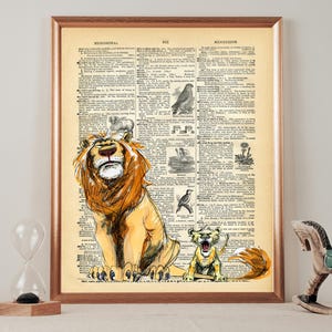 May include: A vintage dictionary page featuring a hand-drawn illustration of a lion and a lion cub. The lion is looking upwards with its mouth open, and the cub is looking to the right with its mouth open. The page is framed in brown.